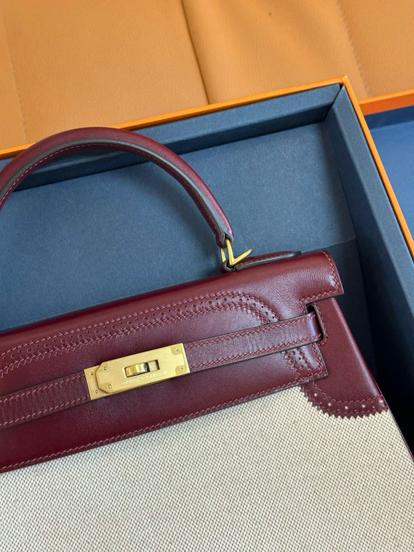 Hermes kelly 25 with red leather trim and a white canvas body