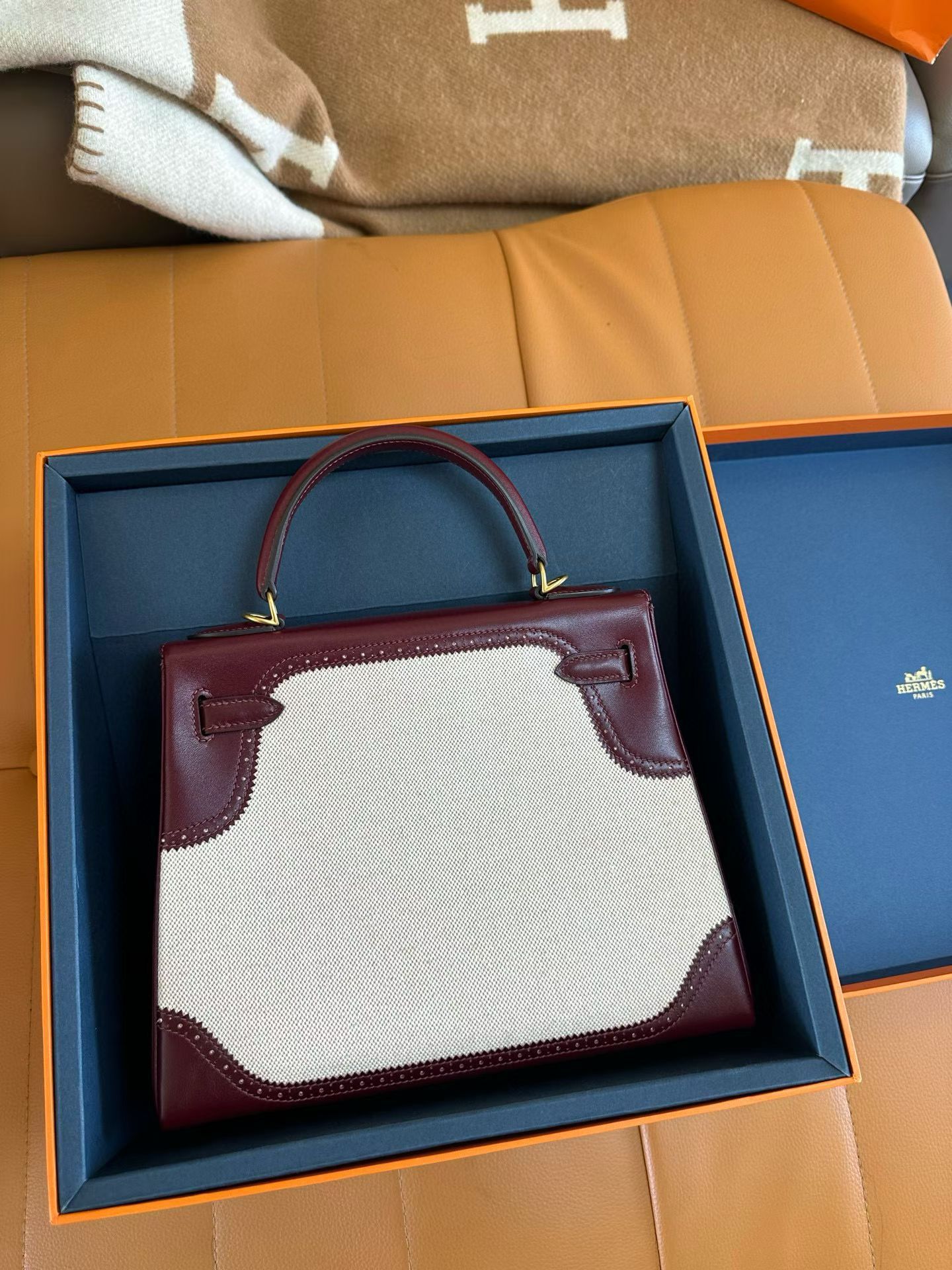 Hermes kelly 25 with red leather trim and a white canvas body